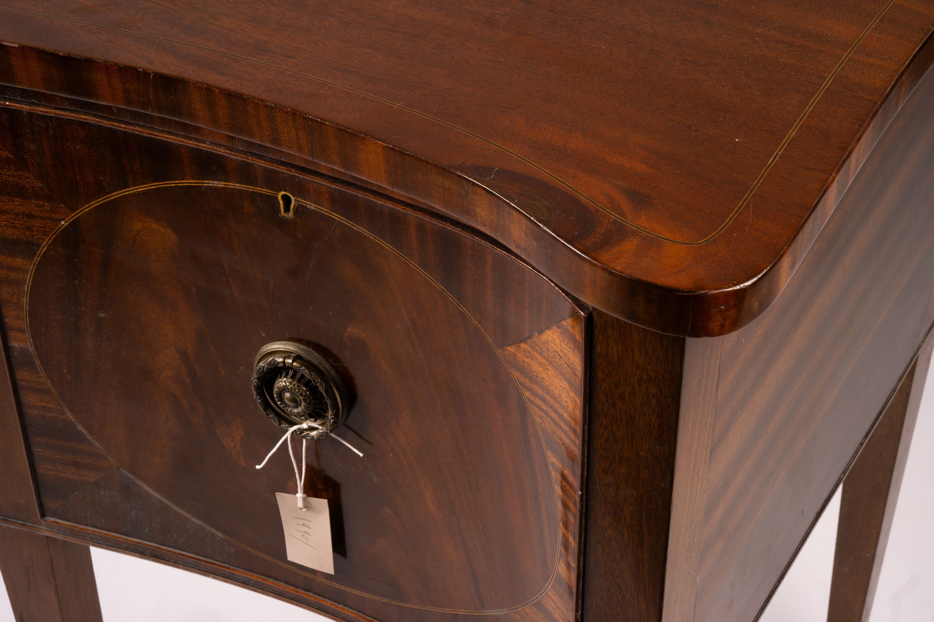 A George III style mahogany serpentine sideboard on square tapered legs, width 184cm, depth 63cm, height 93 cm